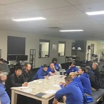 The House Removalists Melbourne team around a table at a crew briefing
